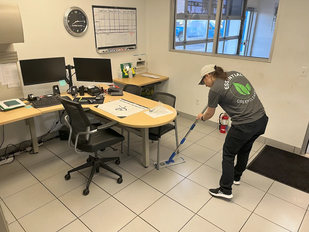 Cleaning person mopping floor in office cubical area