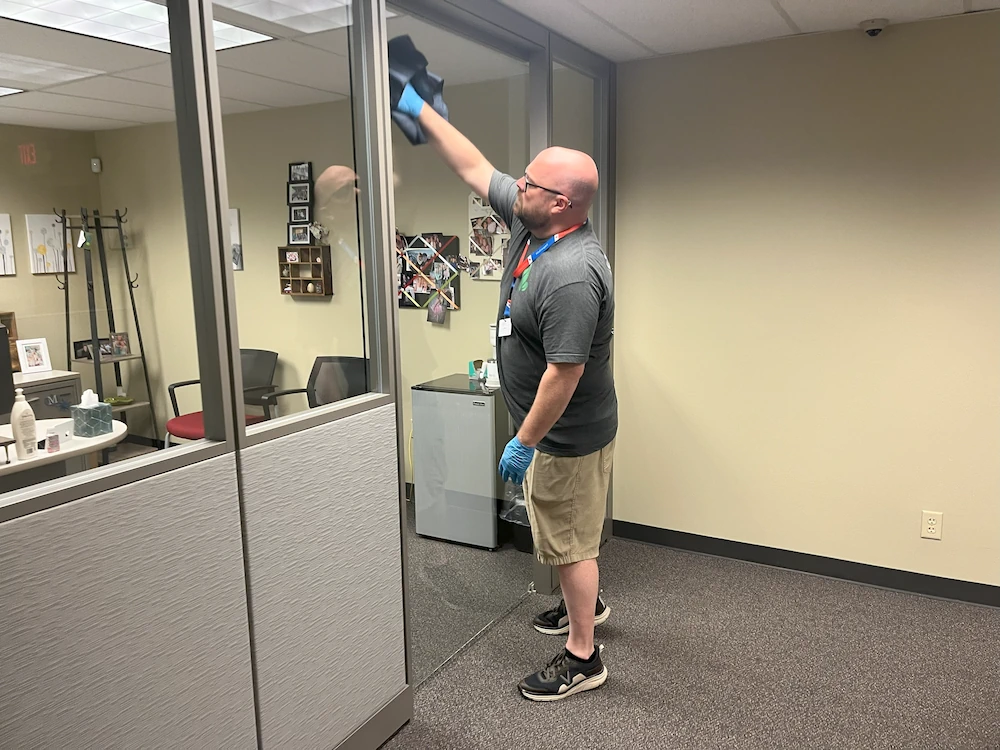 Blake Easter cleaning interior windows for Essential Green Cleaning Janitorial Service
